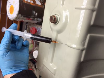 Injecting SW2 oil between the tank and the armour plate with syringe and needle