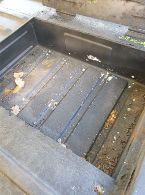 Rust damage in rear footwell.JPG